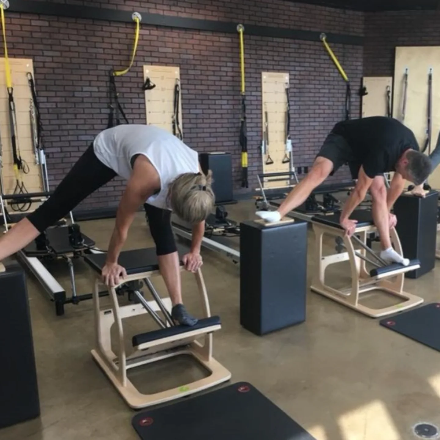 Clients practice together on Pilates chairs in Longview