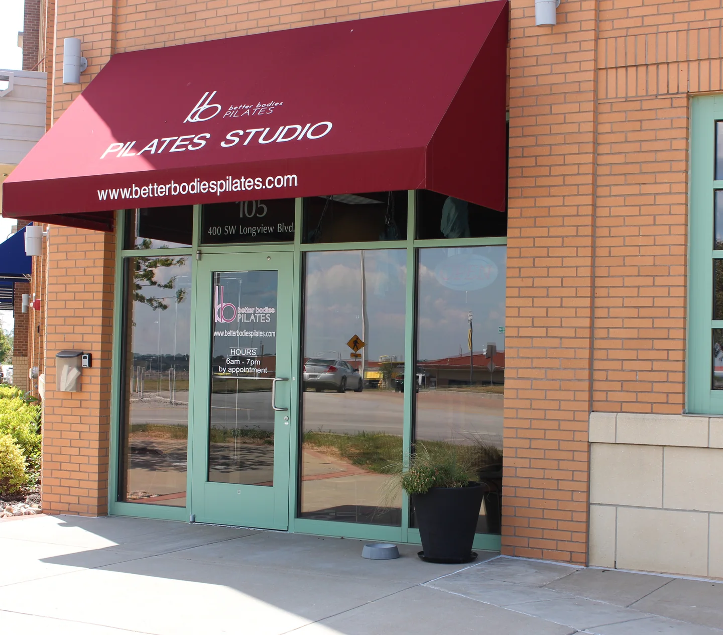 The Better Bodies Pilates entrance in Longview, with its burgundy awning